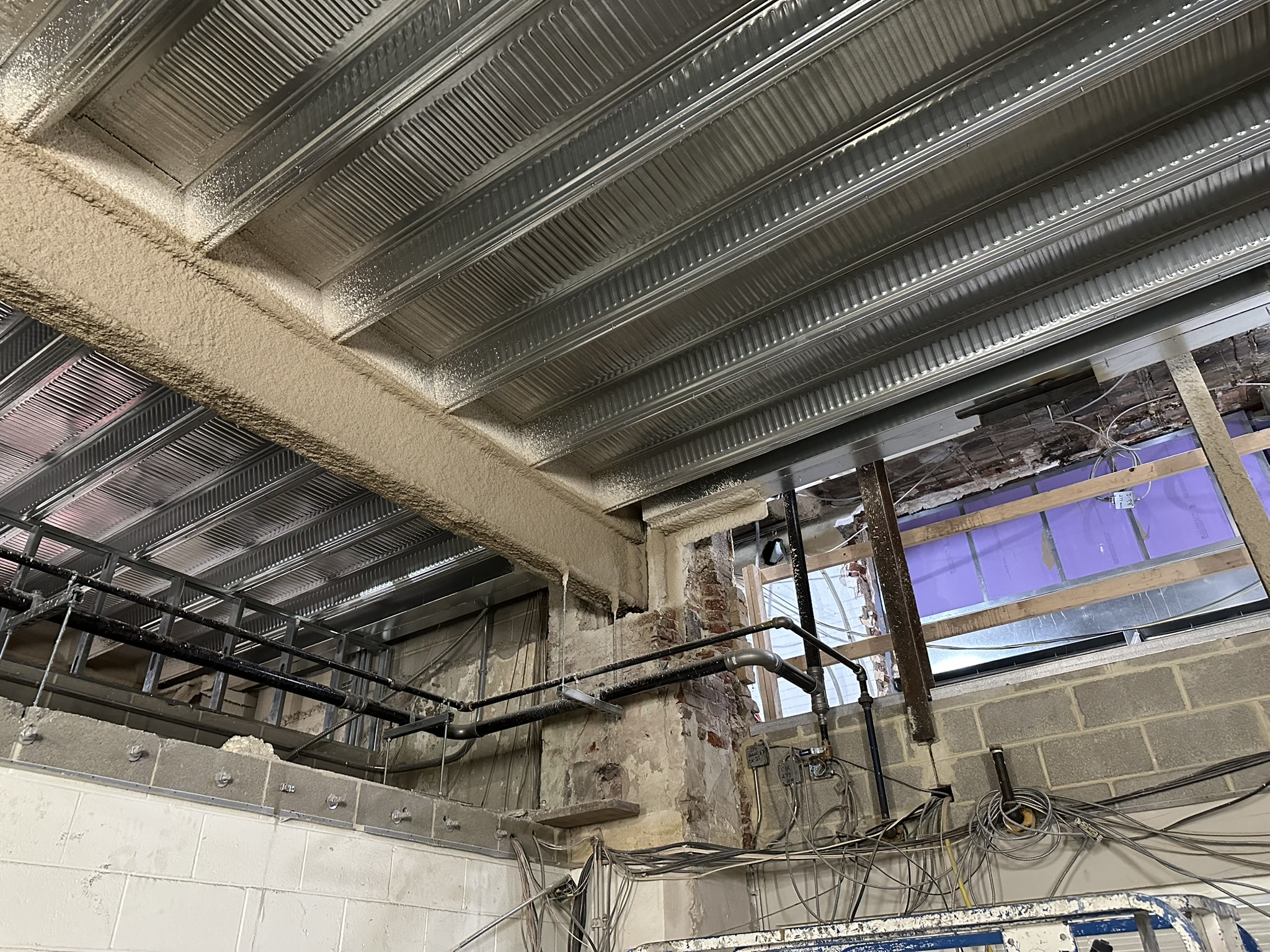 View of new metal deck/framing and existing structure coordination inside Bellevue Bathhouse renovation.