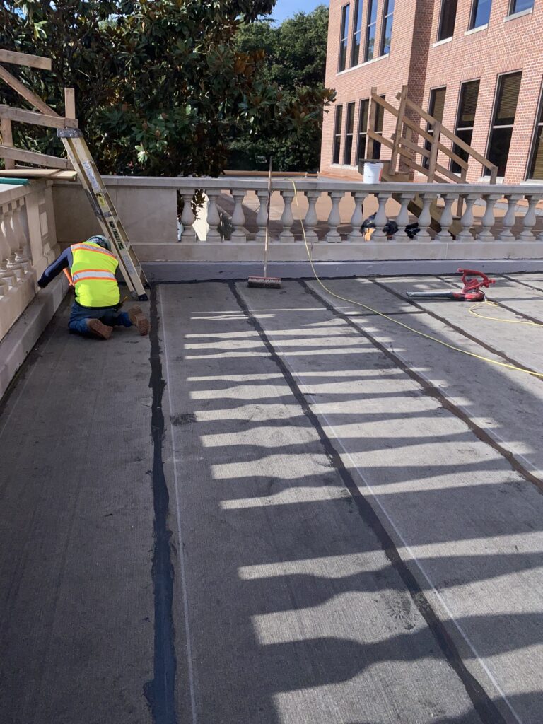 Installation of PUMA liquid-applied waterproofing at McAuley Hall terrace restoration in Baltimore Maryland.